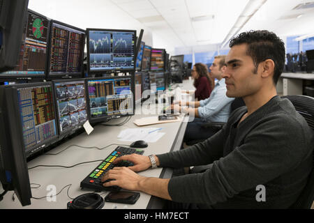 Young traders analyzing computer data Stock Photo