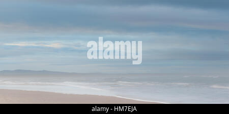 Budle Bay, Northumberland, golden sands, blue sea and blue cloudy sky, panorama Stock Photo