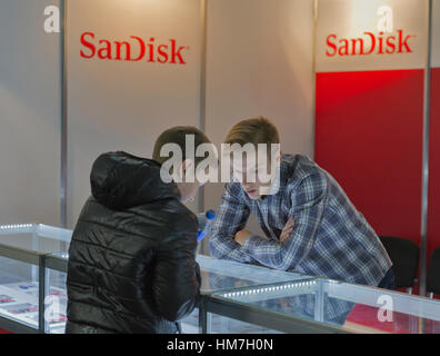 KIEV, UKRAINE - OCTOBER 11, 2015: People visit SanDisk, American electronics manufacturer company booth during CEE 2015, the largest electronics trade Stock Photo