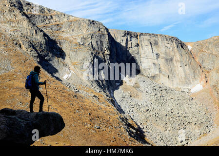 USA, Colorado, Silhouette of hiker on rock ledge along Chicago Lakes Trail in Mount Evans Wilderness Area Stock Photo