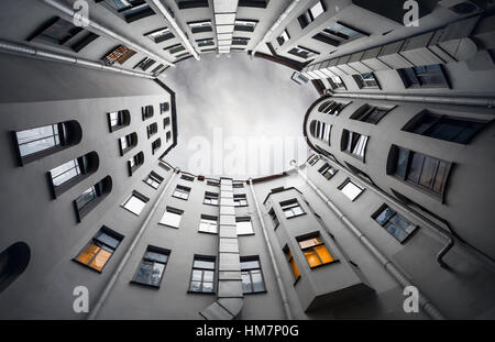 Yard-well of bottom-up with grey sky at twilight, classical architecture of old Saint Petersburg, Russia Stock Photo