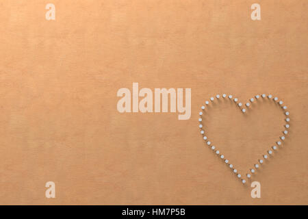 shape of heart made of partially hammered nails in the corner of clear wood, 3d rendering Stock Photo