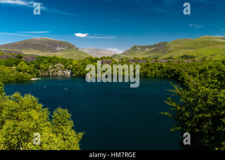 Looking across the disused Dorothea Slate Quarry to Snowdon, Nantlle, Gwynedd, Wales, United Kingdom. Flooded with water. Stock Photo