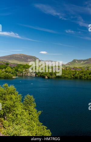 Looking across the disused Dorothea Slate Quarry to Snowdon, Nantlle, Gwynedd, Wales, United Kingdom. Flooded with water. Stock Photo