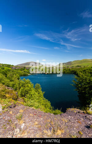 Looking across the disused Dorothea Slate Quarry to Snowdon, Nantlle, Gwynedd, Wales, United Kingdom. Flooded with water. Stock Photo