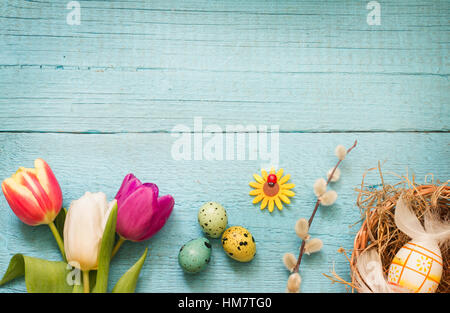 Easter eggs and fresh spring tulips on vintage boards abstract background Stock Photo