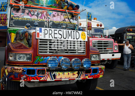 SMUG, CONCEITED, VAIN, SNOOSTY. BUS RED DEVIL DIABLO ROJO PAINTED BUS PANAMA CITY REPUBLIC OF PANAMA. Albrok bus station terminal. Panama. Here comes  Stock Photo