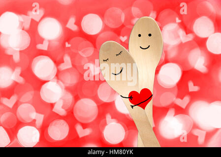 Happy couple hug concept, smiley painted on spoons, valentines day background Stock Photo