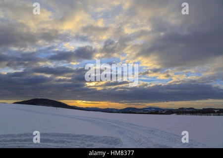 Sunset on the Rothaar Mountains and wintry landscape of the Sauerland, Holthausen, Germany Stock Photo