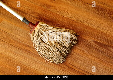 cleaning wooden parquet with old mop Stock Photo