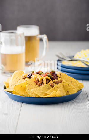 Beef nachos with beers on rustic background Stock Photo