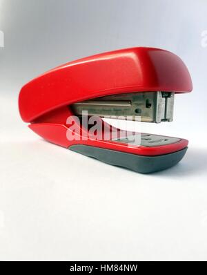 Red stapler against a white background Stock Photo