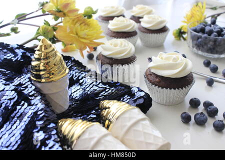 Blue, Yellow, Gold Cupcakes and Sequins Stock Photo