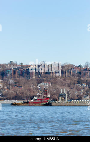 ALPINE, NEW JERSEY, UNITED STATES - January 1, 2017: The Joan Moran tug boat is seen working on the Hudson River near Yonkers, New York. Stock Photo