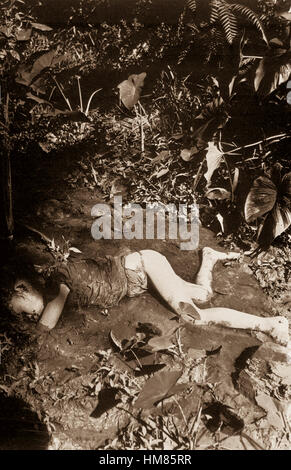 Atrocity committed by the Japs on 9 April 1945 at Bingas, Luzon, Philippine Islands.  Child laying in mud of creek.  April 11, 1945.  T5c. J. Jepson.  (Army) NARA FILE #:  111-SC-212513 WAR & CONFLICT BOOK #:  1251 Stock Photo