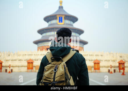 Young traveler standing in front of temple of heaven - in Beijing, China. Asia Travel Stock Photo