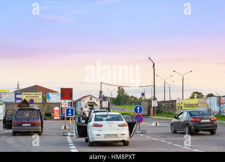 Narva, Estonia - August 20, 2016: Private passenger cars parked in waiting area on Estonian-Russian state border crossing. International automobile tr Stock Photo