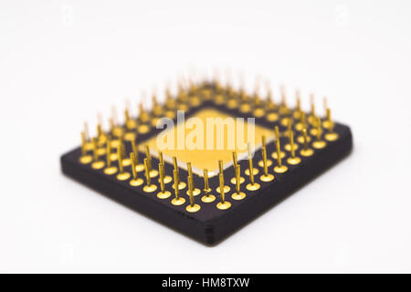 Semiconductor with gold plated pins on a white background. Stock Photo