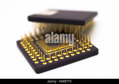 Semiconductor with gold plated pins on a white background. Stock Photo