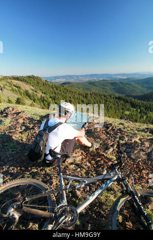 Mountain Biker Reviewing the Trail Map on Oregon's Lookout Mountain Trail Stock Photo