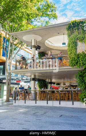 People enjoying drinks at cafe in pedestrian mall Stock Photo