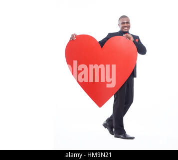 Full lenght portrait of man holding big heart. Stock Photo