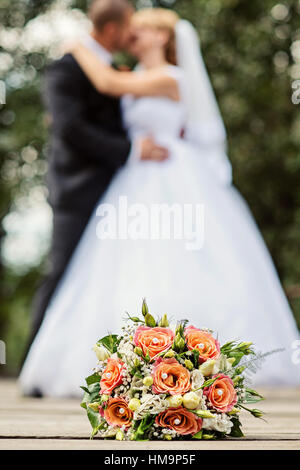 Close up of wedding bouquet with bride and groom Stock Photo