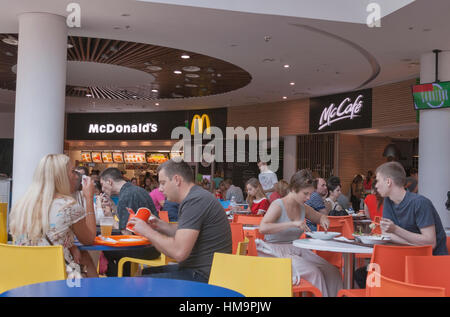 KIEV, UKRAINE - JULY 19, 2015: Unrecognizable people eating in a food court of Ocean Plaza biggest in Ukraine shopping mall with total area of 160.000 Stock Photo