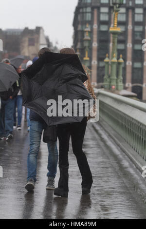 London, UK. 2nd Feb, 2017. Pedestrians struggle with their umbrella  on Westminster Bridge as Storm Doris arrives in London Credit: amer ghazzal/Alamy Live News Stock Photo