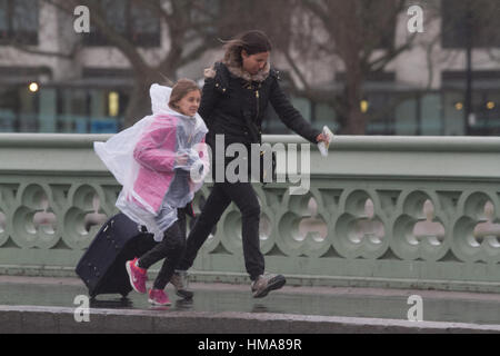 London, UK. 2nd Feb, 2017. Pedestrians run for cover from the rain and windy conditions on Westminster Bridge as Storm Doris arrives in London Credit: amer ghazzal/Alamy Live News Stock Photo