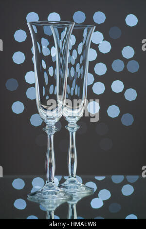 Two empty champagne glasses on blue background Stock Photo