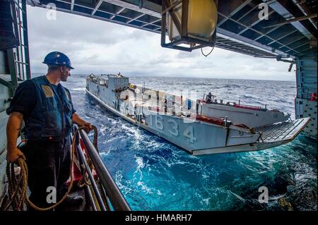 161008-N-XM324-077SOUTH CHINA SEA (Oct. 8, 2016) U. S. Navy Petty Officer 3rd Class David Coburn stands by as Landing Craft, Utility 1634, assigned