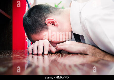 Businessman resting head on the desk at work Stock Photo