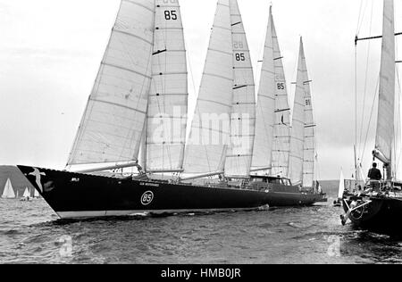 AJAXNETPHOTO. 6TH JUNE,1976. PLYMOUTH, ENGLAND. - OSTAR 1976 - THE HUGE 236FT CLUB MEDITERRANEE SKIPPERED BY ALAIN COLAS MANOUEVERS TOWARD THE START LINE. OVERALL WINNER ERIC TABARLY IN PEN DUICK VI SAILS PAST ON THE RIGHT.   PHOTO:JONATHAN EASTLAND/AJAX REF:2760506 14 Stock Photo