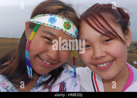 Model released inuit teens throat singing, wearing their traditional clothing. (MR). Pond Inlet, Baffin Island. High Arctic. Canada&#xA;( isolated, re Stock Photo