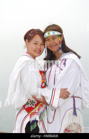 Model released inuit teens throat singing, wearing their traditional clothing. (MR). Pond Inlet, Baffin Island. High Arctic. Canada&#xA;( isolated, re Stock Photo