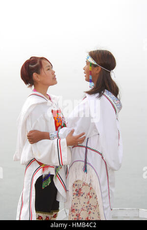 Model released inuit teens throat singing, wearing their traditional clothing. (MR). Pond Inlet, Baffin Island. High Arctic. Canada&#xA;( isolated, re Stock Photo