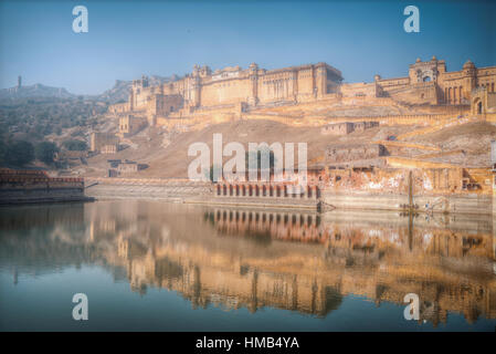 Amber Fort or Amer - fortified residence of Raja in the eponymous northern suburbs of Jaipur, on the crest of a rocky hill behind the lake Maota Stock Photo