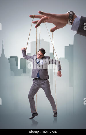 Businessman puppet being manipulated by boss Stock Photo