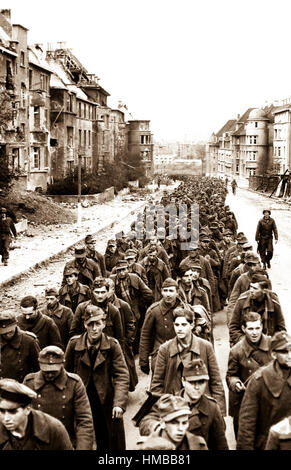 German prisoners of war marching through the ruined city of Aachen. Oct ...