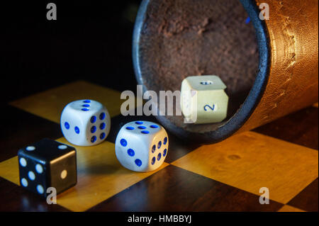 Different type of dice on a chess board Stock Photo