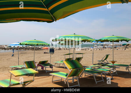 many parasols and deck chairs on the beach resort in summer Stock Photo