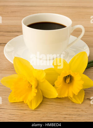 Cup of Coffee and Two Daffodils Stock Photo