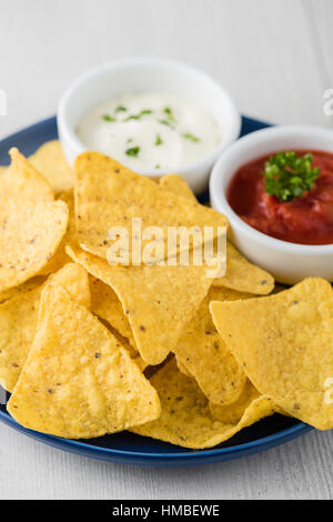 Nachos with salsa and sour cream dips Stock Photo