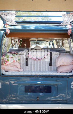 Open back of a retro camper van, with luggage, vertical Stock Photo