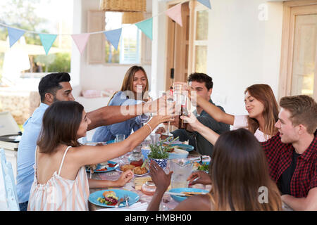 Friends making a toast at a dinner party on a patio, Ibiza Stock Photo