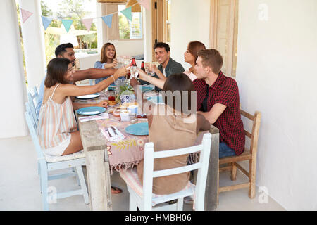 Friends making a toast at a dinner party on a patio, Ibiza Stock Photo