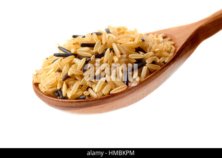 Brown and black rice in wooden spoon on white Stock Photo