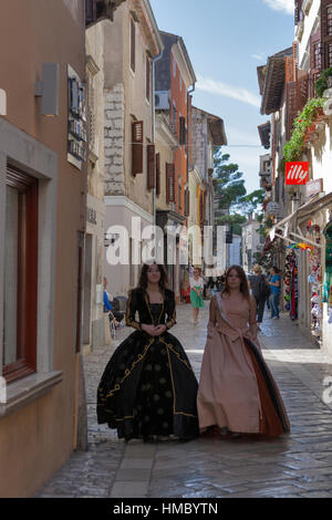 POREC, CROATIA - SEPTEMBER 14, 2014: Unrecognizable girls dressed in medieval clothes on the streets of the city during 8th Historical Festival Giostr Stock Photo