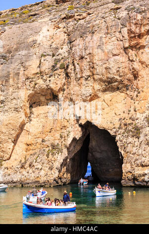 excursion boats travelling from the inland lagoon through the arch to the azure window, gozo, malta Stock Photo